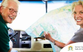 An older couple looks back smiling from the front of an RV, representing how day trips for seniors can help boost the mood of everyone.