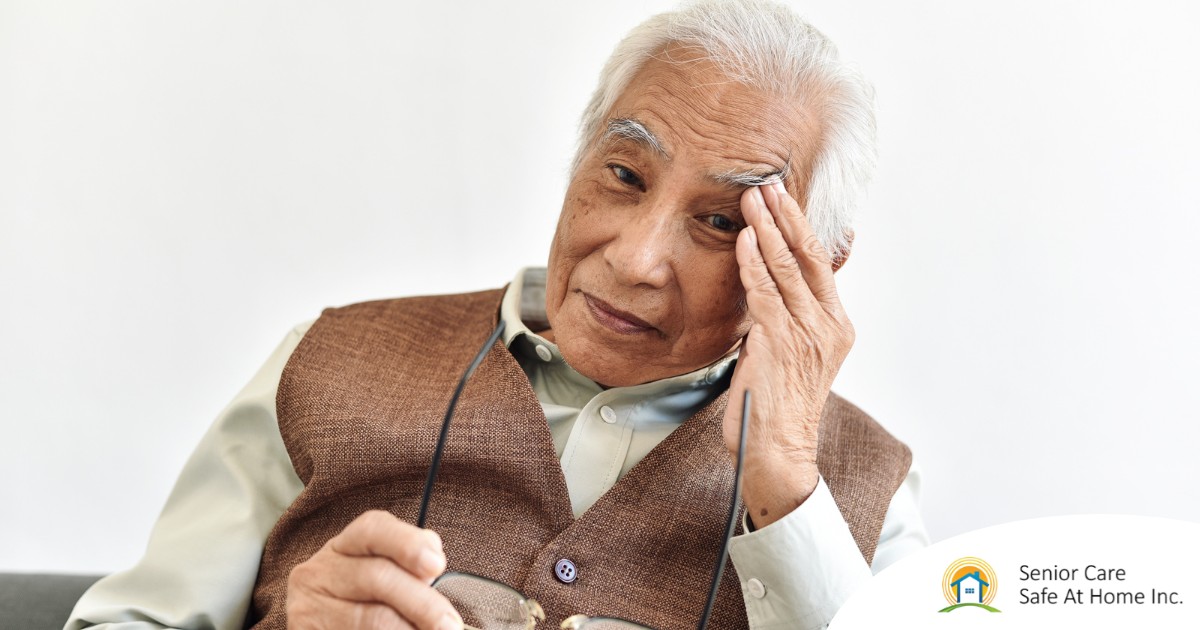 Living Well with Macular Degeneration Adapting to Vision Changes An older adult holds his head and his glasses representing vision problems like macular degeneration.