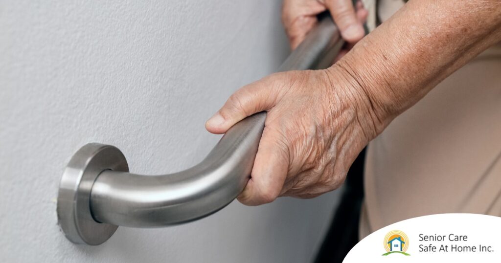 An older adult uses a grab bar representing one of the home modifications that is helpful for fall prevention for elderly adults.