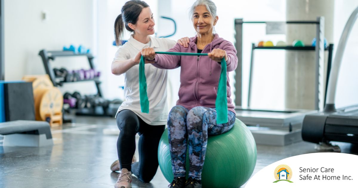 Stay Active, Stay Safe Simple Exercises for Senior Fall Prevention A care provider helps an older woman exercise with a resistance band and an exercise ball, representing how exercise can help with senior fall prevention.